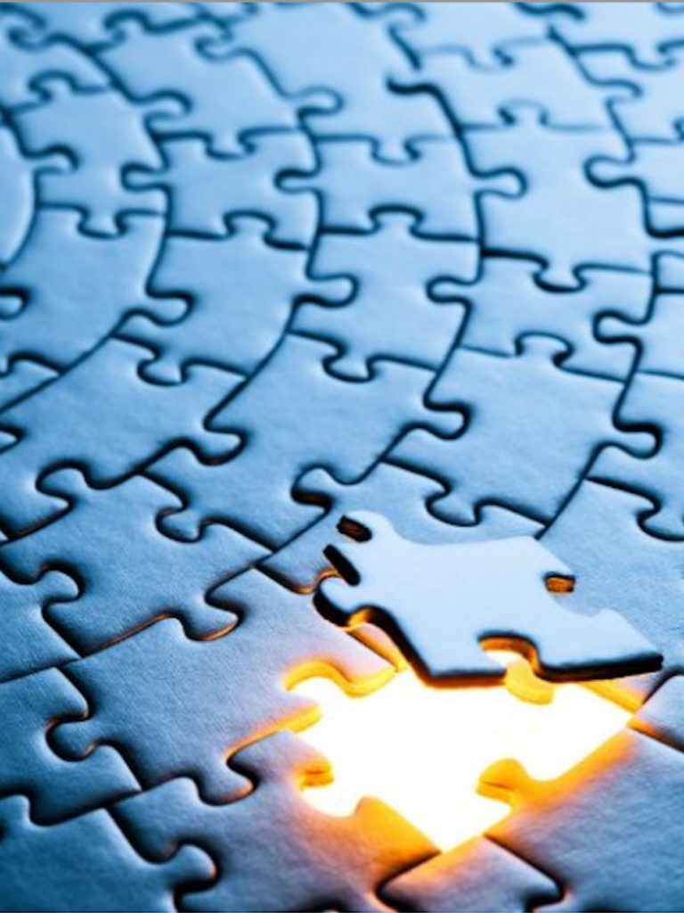 Image of a circular jigsaw, with one piece missing and a light under it to represent that is missing in the business.